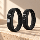 Two black WAKE™ bracelets on warm limestone, shown as a couples set